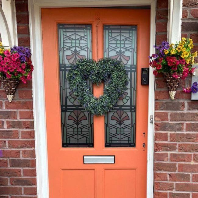 Beatrice pink stained glass window film installed onto an orange door