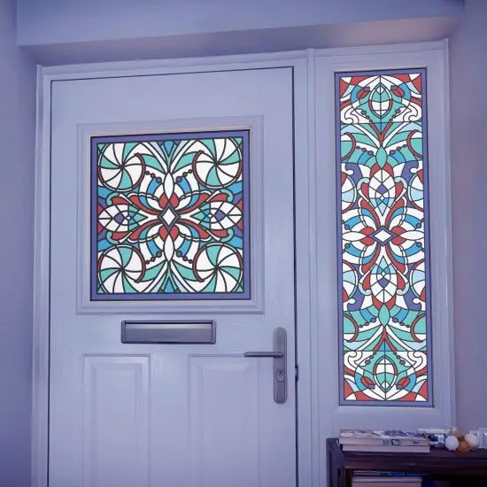 A blue and red stained glass design with detailed shapes and swirls installed onto a front door