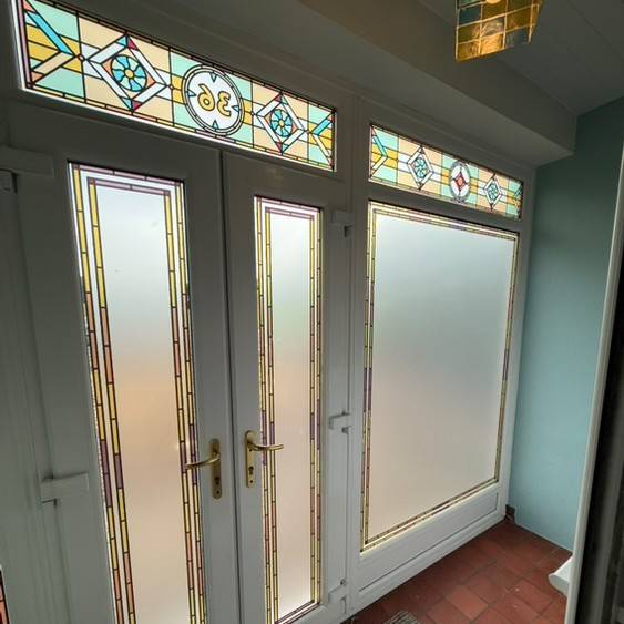 A custom design based of the Julian stained glass installed on A front door
