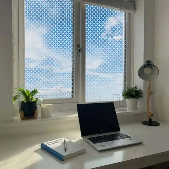 Circle and diamond patterned window film installed onto a home office window