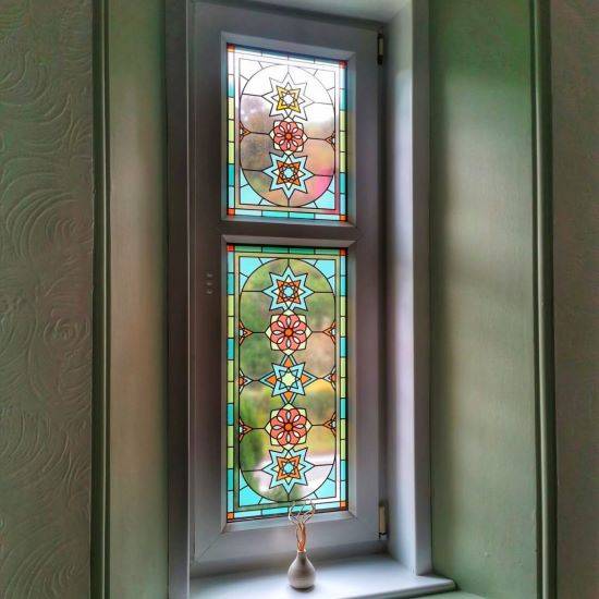 Julian stained glass window film installed in a curved hotel room