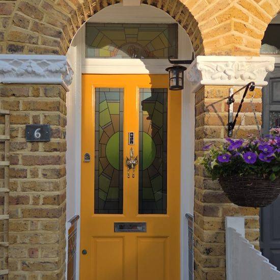 Kyoko Sun Stained Glass Window Film Installed In and Above a Yellow Front Door