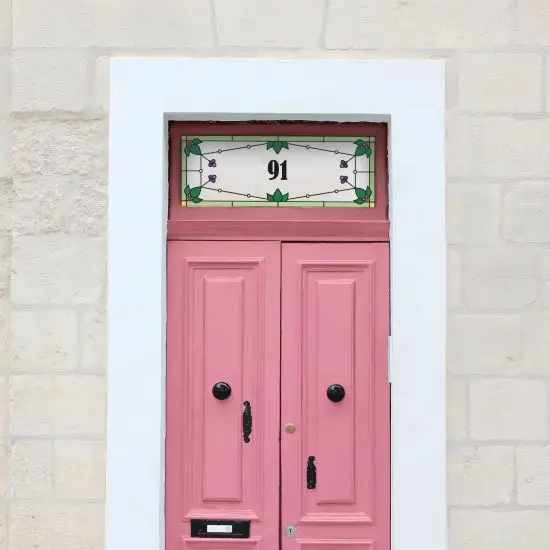 Elsie stained glass door number with leaves on a pink front door