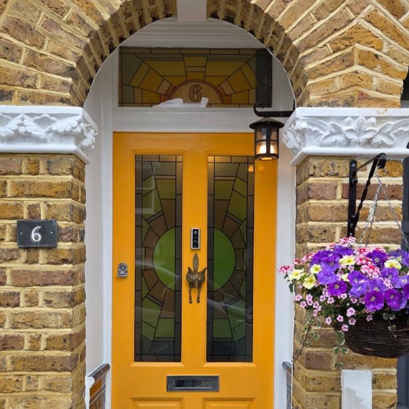 Kyoko stained glass window film set installed on a yellow front door