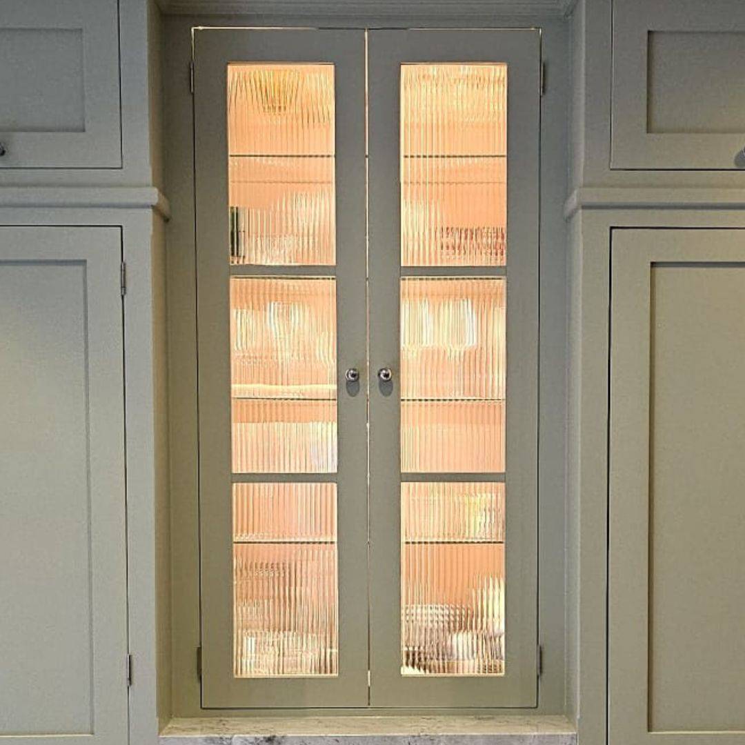 Reeded glass window film installed into a tall kitchen cabinet