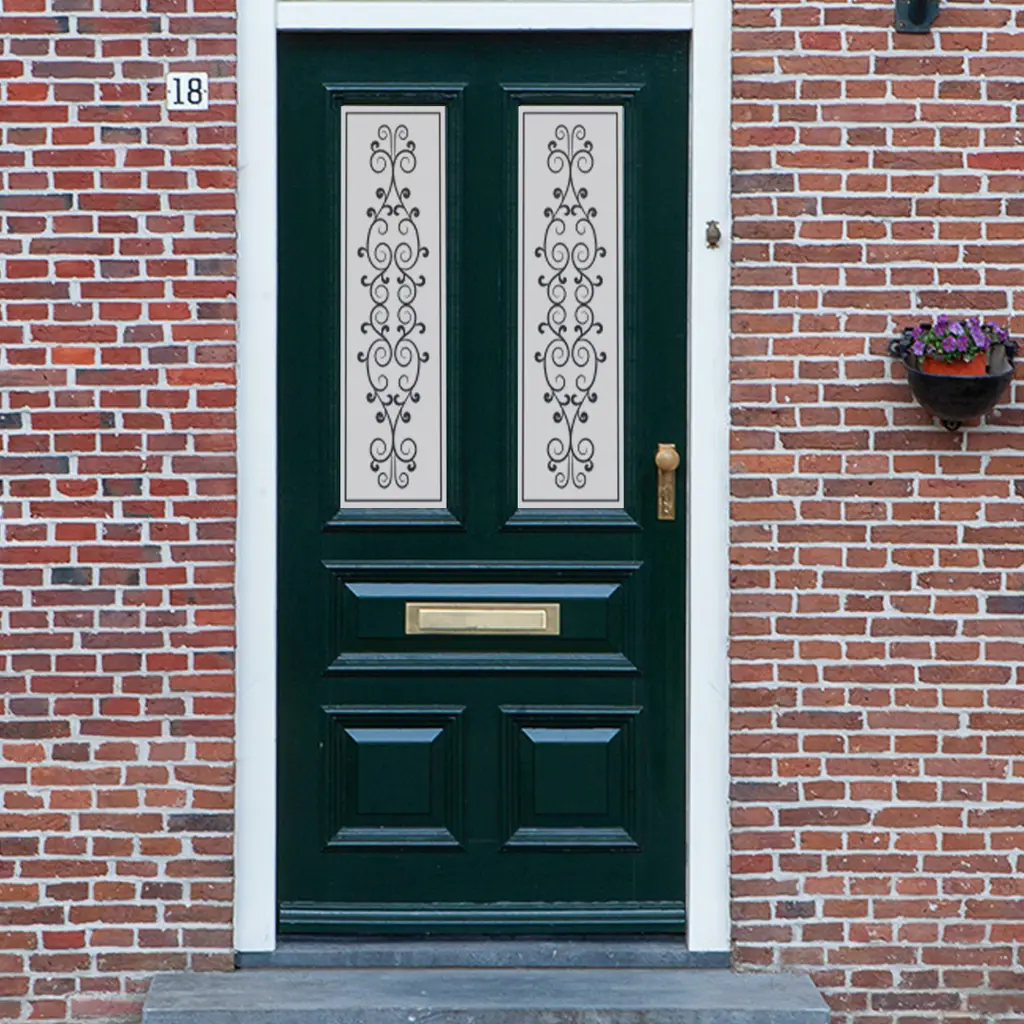 A Victorian frosted glass design with swirls and heart shapes on a traditional front door